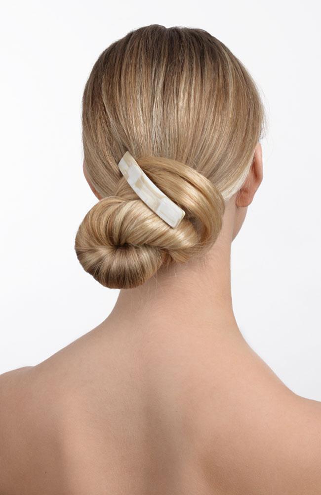 Alba white French barrette holding bun in blonde hair
